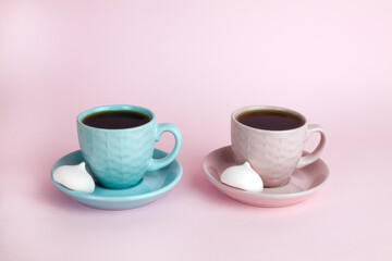 Two cups of coffee on the pink background. Place for text. Close-up.