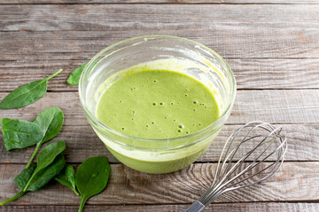 Raw ingredients for cooking healthy spinach pancakes on table. Gluten free spinach pancakes recipe
