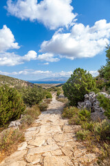 Fototapeta na wymiar The Byzantine Path, a popular trekking trail in Paros island, Cyclades, Greece, Europe, connecting the traditional villages of Lefkes and Prodromos, through fields, hills and spectacular landscape.