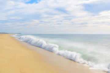 Set of pictures of a fantastic ocean wave in different stages. Cloudy sunrise sky. San Jose del Cabo. Mexico.