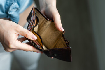 Woman holding an empty wallet