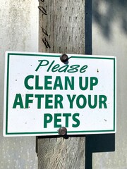 Waring sign for pets owners,  green letters on white.