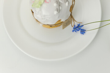 Orthodox cake on a plate with a blue flower top view on a white background