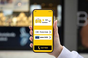 female hand holding golden phone with taxi call application