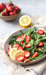 Healthy organic diet salad with arugula, strawberries and almonds.	
