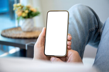 male hands holding golden phone with isolated screen background room