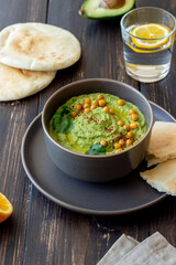 Avocado hummus in a gray bowl. Healthy eating. Vegetarian food.