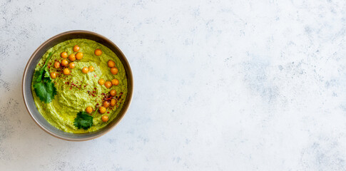 Avocado hummus in a gray bowl. Healthy eating. Vegetarian food.