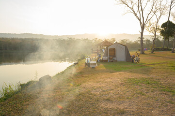 Fototapeta premium Camping Tent near river in the morning, traveling and holidays concept