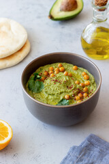 Avocado hummus in a gray bowl. Healthy eating. Vegetarian food.