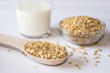 Oatmeal and a glass of milk on a white background.