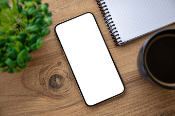 golden phone with isolated screen on wooden table in office
