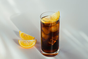 Glass of cola with ice and lemon