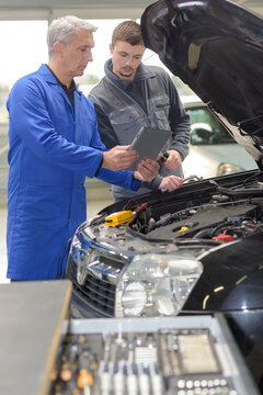 student repairing car in automotive vocational school