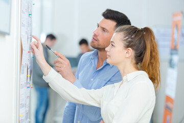 man and young woman working together in an office