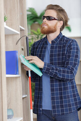 blind man trying to find the right for a book