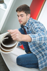 a contractor is unrolling underlay