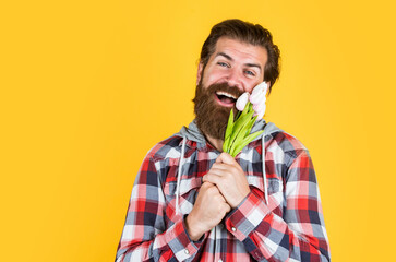 spring holiday present. happy valentines day. mature guy in checkered shirt with tulip flowers....