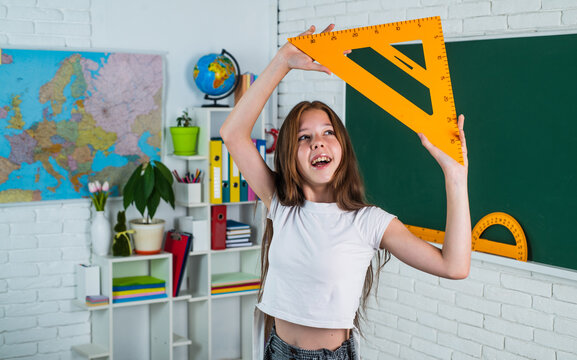teen girl with triangle ruler. back to school. concept of education. measuring angle degree.