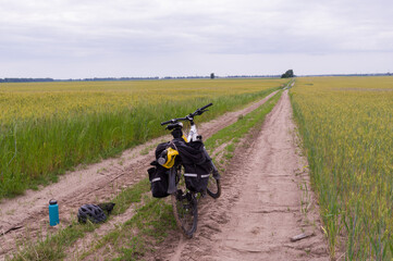 Obraz premium Tourist bike with bags. Tourist bike on the road. Cycling travel.