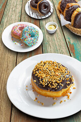 Various donuts on a table. Front view.