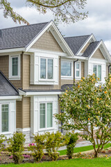 A perfect neighborhood. Houses in suburb at Spring in the north America. Fragment of a luxury house with nice window.