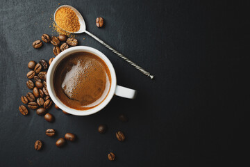 Steaming espresso served in cup on dark