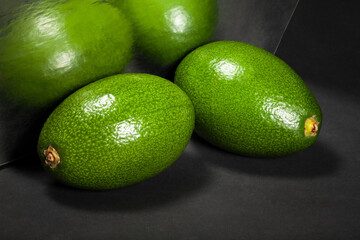 mirrored avocado on black background