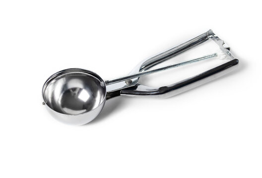 Ice cream scoop, cookie scoop or disher with squeeze handle for easy release. Stainless steel kitchen tool or gadget, to evenly proportion out dough, batter or ice cream. Isolated. Selective focus.