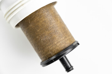 Dirty filter cartridge drinking water on a white background. Replacing cartridges is a mandatory procedure that must be carried out to maintain quality water purification. Pollution.