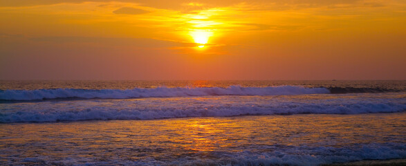 Naklejka na ściany i meble Beautiful sunrise over the tropical beach. Wide photo.
