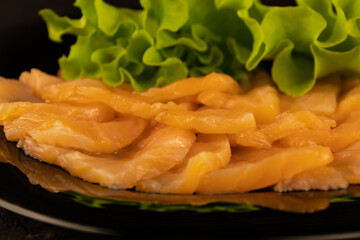 Salmon slices with greens