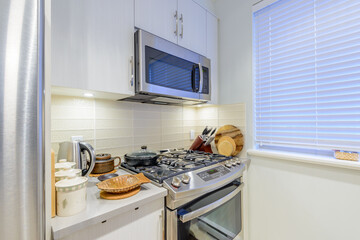 Modern, bright, clean, kitchen interior with stainless steel appliances in a luxury house