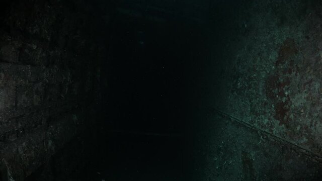 Unique underwater scuba divers view of the inside of a sunken shipwreck to reveal a dark chamber of the recently scuttled Australian Navy ship the Ex-HMAS Tobruk to provide an artificial reef.