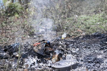 Environmental pollution (polución), mixture of organic and inorganic domestic waste being burned in the open air on a farm