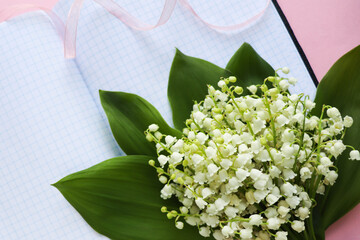 spring flowers. small bouquet of lilies of the valley and space for text 