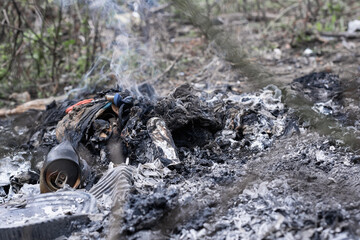 Environmental pollution (polución), mixture of organic and inorganic domestic waste being burned in the open air on a farm