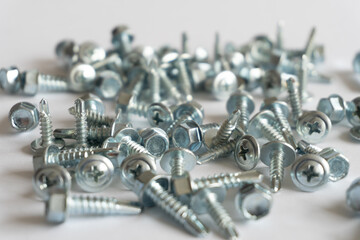 screws piled up on a white background. Construction concept