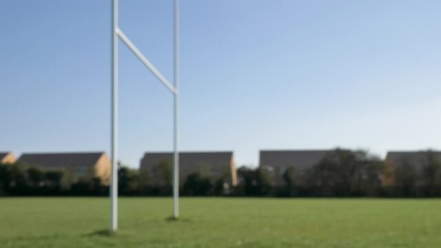 Defocused Wide Shot of Rugby Ball Flying Through Rugby Posts