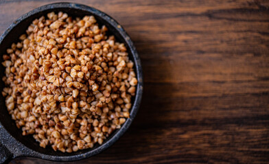 Buckwheat in a pan on wooden boards