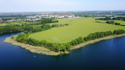Naklejka premium aerial view of a lake with trees and reed 