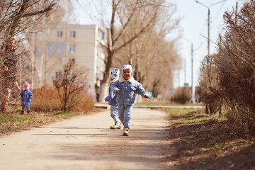 Two African-American boys running in the street