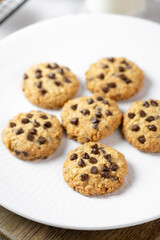 Delicious Whole Wheat Chocolate Chip Cookies set on white cafe table.