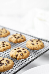 Delicious Whole Wheat Chocolate Chip Cookies set on white cafe table.