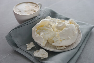 Large meringue on a plate and a blue napkin