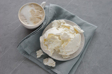 Large meringue on a plate and a blue napkin
