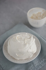 Large meringue on a plate and a blue napkin