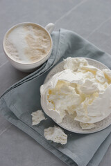 Large meringue on a plate and a blue napkin