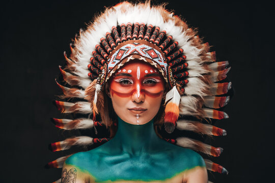 Woman Painted And Dressed In Native American Style In Studio