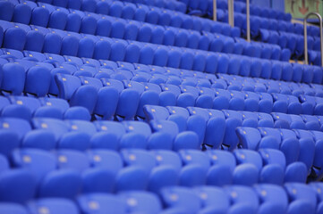 The empty blue plastic seat at stadium.